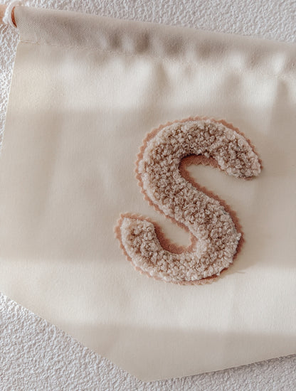 Banner met teddy initiaal